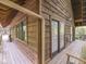 Exterior view of a rustic cabin featuring a charming covered porch, wooden siding, and a serene ambiance at 6486 Coyote Dr, Nineveh, IN 46164