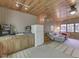 Cozy living area with wood ceiling, kitchenette, comfortable seating, and lots of natural light from the windows at 6486 Coyote Dr, Nineveh, IN 46164