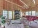 Cozy living room featuring a wood-burning fireplace, comfortable seating, and natural light from large windows at 6486 Coyote Dr, Nineveh, IN 46164