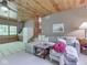 The cozy living room features a gray couch, wood-paneled ceiling, and is perfect for relaxation and gathering at 6486 Coyote Dr, Nineveh, IN 46164