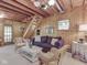 Comfortable living room area with wood paneling, staircase and wicker furniture at 6486 Coyote Dr, Nineveh, IN 46164