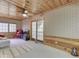 Bright living area featuring a wooden ceiling, light-colored walls, a sliding glass door, and a ceiling fan at 6486 Coyote Dr, Nineveh, IN 46164