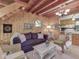 Comfortable living room area with wood paneling, staircase and wicker furniture at 6486 Coyote Dr, Nineveh, IN 46164