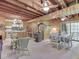 Open living space featuring wood walls, a fireplace, a dining table, and a kitchen in the background at 6486 Coyote Dr, Nineveh, IN 46164