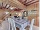 Cozy living area with wood paneling, a staircase, dining table, and comfortable seating at 6486 Coyote Dr, Nineveh, IN 46164