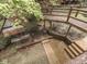 Outdoor kitchen and wooden walkways with natural forest backdrop and wooded surroundings at 6486 Coyote Dr, Nineveh, IN 46164