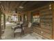 Covered patio features rustic wood paneling and comfortable seating with wooded views at 6486 Coyote Dr, Nineveh, IN 46164