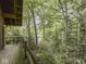A wood deck overlooks a lush wooded area, and the view ends on the water at 6486 Coyote Dr, Nineveh, IN 46164