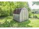 Backyard storage shed surrounded by lush green grass and shady trees at 2925 Highwoods Dr, Indianapolis, IN 46222
