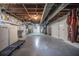Unfinished basement with exposed ductwork, lighting, washer, dryer, and ample storage space at 2925 Highwoods Dr, Indianapolis, IN 46222
