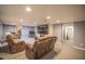 Finished basement with a large television, fireplace, carpet, and comfortable seating great for entertainment at 2925 Highwoods Dr, Indianapolis, IN 46222