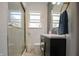 Modern bathroom with a glass-enclosed shower and a stylish vanity with gold fixtures at 2925 Highwoods Dr, Indianapolis, IN 46222