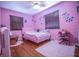A cozy bedroom with pink walls, hardwood floors, and a cozy atmosphere perfect for relaxation at 2925 Highwoods Dr, Indianapolis, IN 46222