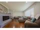 Spacious living room with a stone fireplace, hardwood floors, and ample seating at 2925 Highwoods Dr, Indianapolis, IN 46222