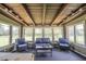Bright sunroom with wicker furniture, a wood paneled ceiling and many windows offering scenic views at 2925 Highwoods Dr, Indianapolis, IN 46222