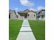 Charming home with well-maintained lawn, a concrete walkway, and a welcoming front porch with decorative columns at 547 Udell St, Indianapolis, IN 46208