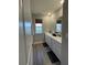 Bathroom featuring a window, double sink vanity, and laminate floors at 7108 Parkstay Ct, Indianapolis, IN 46113