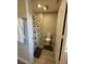 Small bathroom featuring tile flooring, toilet, and decorative shower curtain at 7108 Parkstay Ct, Indianapolis, IN 46113