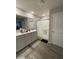 Well-lit bathroom featuring double sink vanity, framed mirror, walk-in shower, and wood-look flooring at 7108 Parkstay Ct, Indianapolis, IN 46113