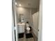 Compact bathroom with a toilet, vanity, and shower-tub combination with wood-look flooring at 7108 Parkstay Ct, Indianapolis, IN 46113