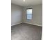 Bedroom with neutral walls, carpet flooring, and natural light from a window at 7108 Parkstay Ct, Indianapolis, IN 46113