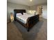 Bedroom with plush carpeting and a large bed and doorway to another room at 7108 Parkstay Ct, Indianapolis, IN 46113