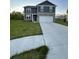 Two story home with blue siding, stone veneer, large front yard, and two car garage at 7108 Parkstay Ct, Indianapolis, IN 46113