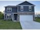 Two story home with blue siding and stone veneer and a two car garage at 7108 Parkstay Ct, Indianapolis, IN 46113