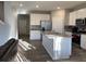 Updated kitchen boasts stainless steel appliances and a large island at 7108 Parkstay Ct, Indianapolis, IN 46113