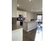 Open concept kitchen with a large island, stainless steel microwave, and adjacent dining area at 7108 Parkstay Ct, Indianapolis, IN 46113