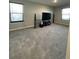 Spacious living room area with plush carpeting, neutral walls and a large window at 7108 Parkstay Ct, Indianapolis, IN 46113