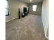 Spacious living room area with plush carpeting, neutral walls and a large window at 7108 Parkstay Ct, Indianapolis, IN 46113