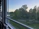 View of a treelined walking path along a river with sunlight filtering through the trees at 7108 Parkstay Ct, Indianapolis, IN 46113