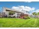 Spacious back yard with green grass, mature trees, and a charming deck offers a serene outdoor retreat at 778 Kingston Cir, Brownsburg, IN 46112