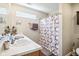 Bright bathroom with double vanity, white countertop, and shower-tub combination at 778 Kingston Cir, Brownsburg, IN 46112