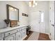 Bright entryway features hardwood floors, white console table and door with decorative rug at 778 Kingston Cir, Brownsburg, IN 46112