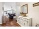 Bright entryway features hardwood floors, white console table and mirror, flowing into the living room at 778 Kingston Cir, Brownsburg, IN 46112