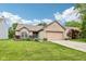 Charming brick home features a two-car garage, manicured lawn, and a welcoming entrance at 778 Kingston Cir, Brownsburg, IN 46112