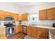 Well-lit kitchen with wooden cabinets, stainless steel appliances, and laminate countertops at 778 Kingston Cir, Brownsburg, IN 46112