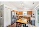 Charming kitchen with stainless steel refrigerator, wooden cabinets, and dining table at 778 Kingston Cir, Brownsburg, IN 46112