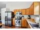 Functional kitchen with stainless steel appliances, wooden cabinets, and laminate countertops at 778 Kingston Cir, Brownsburg, IN 46112