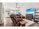 Spacious living room features a plush leather sectional, ceiling fan, and hardwood floors at 778 Kingston Cir, Brownsburg, IN 46112