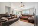 Spacious living room features a plush leather sectional, ceiling fan, and hardwood floors at 778 Kingston Cir, Brownsburg, IN 46112
