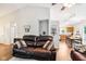 Open concept living room with hardwood floors and a view into the adjacent kitchen at 778 Kingston Cir, Brownsburg, IN 46112
