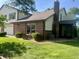 View of the rear exterior showing the brick construction and siding and yard with mature trees at 2424 N Willow Way, Indianapolis, IN 46268