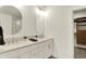 Elegant bathroom with double vanity, modern mirrors, and walk-in closet entrance at 527 E North St, Indianapolis, IN 46204