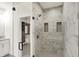 Modern bathroom with glass shower and access to closet with built-in shelving at 527 E North St, Indianapolis, IN 46204