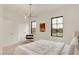 Bright bedroom featuring black trimmed windows, neutral decor, and a contemporary light fixture at 527 E North St, Indianapolis, IN 46204