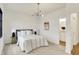 Bright bedroom featuring neutral decor, soft carpet, and a stylish contemporary light fixture at 527 E North St, Indianapolis, IN 46204