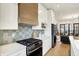Modern kitchen with quartz countertops, stainless appliances and a light-toned backsplash at 527 E North St, Indianapolis, IN 46204